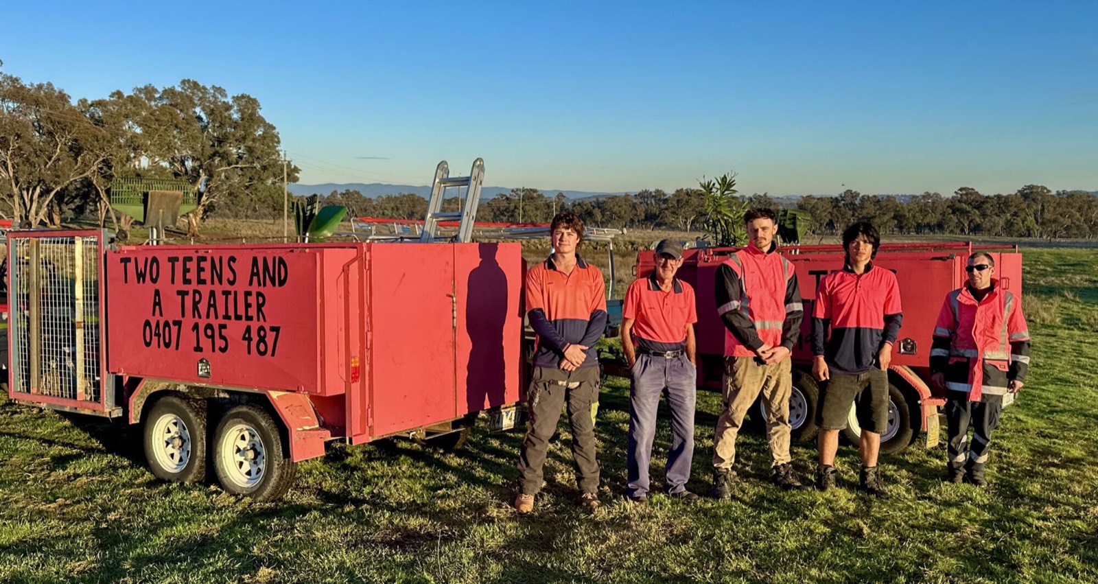 The Two Teens and a Trailer crew with the iconic pink trailer